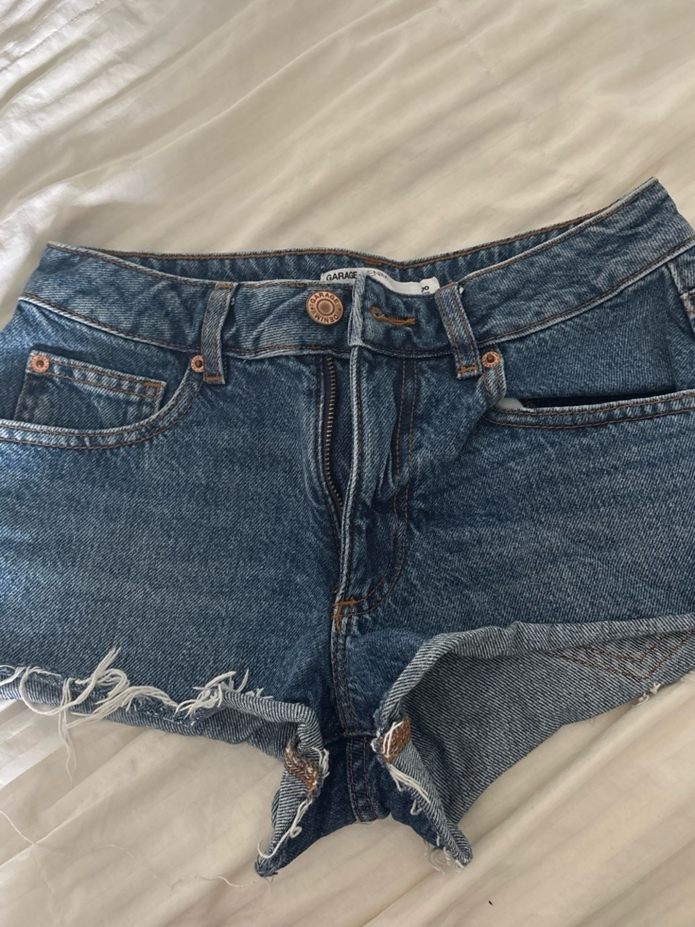 Garage Distressed High-Rise Denim Cutoff Shorts in Medium Blue